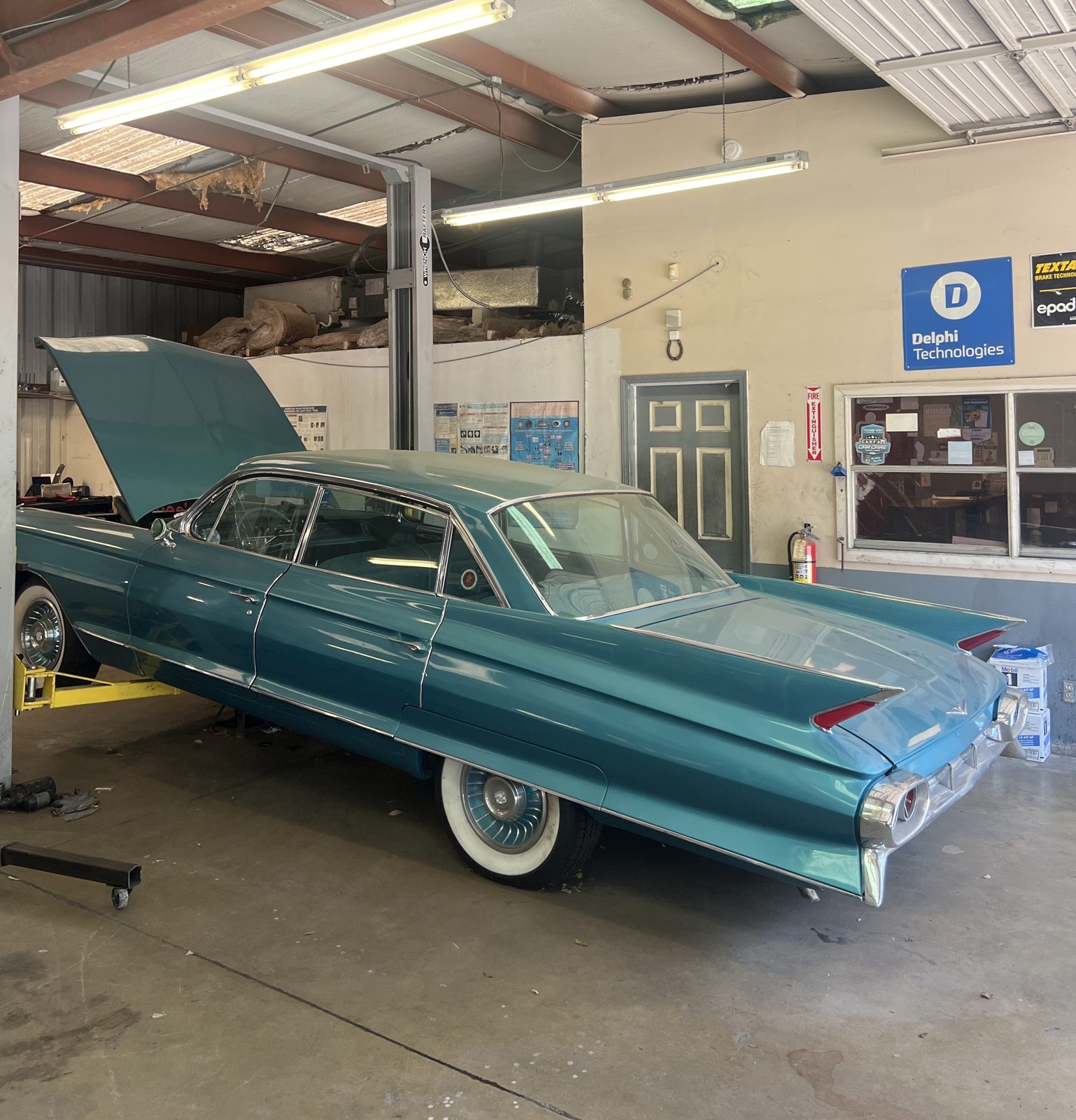 Classic 1961 Cadillac on the lift at Abee's